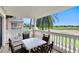 Outdoor balcony with a white table and four chairs with a view of the golf course at 1360 Centre Court Ridge Dr # 201, Reunion, FL 34747