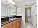Bathroom with vanity and a shower/tub combo, featuring a large framed mirror and tile floors at 1360 Centre Court Ridge Dr # 201, Reunion, FL 34747