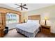 Bedroom featuring a large window with a view, ceiling fan, bedside lamps, and a comfortable bed at 1360 Centre Court Ridge Dr # 201, Reunion, FL 34747