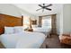 Bedroom with two beds, a ceiling fan, and a view of a window and exterior, designed for comfort at 1360 Centre Court Ridge Dr # 201, Reunion, FL 34747