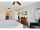 Spacious bedroom featuring a TV, dresser, and views into the Primary bathroom and dining area for comfort at 1360 Centre Court Ridge Dr # 201, Reunion, FL 34747