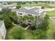 Aerial view of the building showcasing its balconies, landscaping, and proximity to the golf course at 1360 Centre Court Ridge Dr # 201, Reunion, FL 34747
