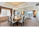 Open concept dining room and living room with plush carpet and decorative ceiling with golf course view at 1360 Centre Court Ridge Dr # 201, Reunion, FL 34747