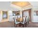 Open concept dining room and kitchen with wooden table and chairs and breakfast bar area at 1360 Centre Court Ridge Dr # 201, Reunion, FL 34747