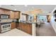 Spacious kitchen with wood cabinets, granite countertops, stainless steel appliances and an open floorplan at 1360 Centre Court Ridge Dr # 201, Reunion, FL 34747