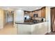 Kitchen featuring granite countertops, stainless steel appliances, and wood cabinets with breakfast bar seating at 1360 Centre Court Ridge Dr # 201, Reunion, FL 34747