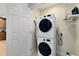 Functional laundry area with stacked washer and dryer, shelving, and a door leading to another room at 1360 Centre Court Ridge Dr # 201, Reunion, FL 34747