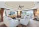 Bright living room with plush carpet, white couches, and a golf course view from the sliding glass doors at 1360 Centre Court Ridge Dr # 201, Reunion, FL 34747