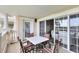 This covered patio features an outdoor dining set and sliding doors leading to the home's interior at 1360 Centre Court Ridge Dr # 201, Reunion, FL 34747