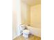 Bright bathroom featuring a toilet, and a white tiled bathtub at 15090 Waterford Chase Pkwy, Orlando, FL 32828