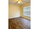 A well-lit bedroom featuring wood flooring and a ceiling fan at 15090 Waterford Chase Pkwy, Orlando, FL 32828