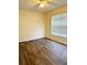 A well-lit bedroom featuring wood flooring and a ceiling fan at 15090 Waterford Chase Pkwy, Orlando, FL 32828