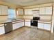 Functional kitchen with stainless steel appliances, tile floors, and white cabinets at 15090 Waterford Chase Pkwy, Orlando, FL 32828