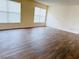 Spacious living room with wood floors and large windows at 15090 Waterford Chase Pkwy, Orlando, FL 32828