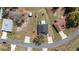 Bird's-eye view of a house with a dark roof surrounded by mature trees and neighboring homes at 154 Pecan Dr, Ocala, FL 34472
