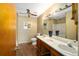Well-lit bathroom with double vanity, wood cabinets, and a large mirror at 154 Pecan Dr, Ocala, FL 34472