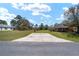 A long driveway leading to the house and a shed at 154 Pecan Dr, Ocala, FL 34472