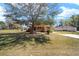 Charming home featuring a spacious front yard with mature tree offering ample shade and curb appeal at 154 Pecan Dr, Ocala, FL 34472