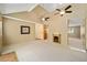 Bright living room with carpet, vaulted ceiling, fan, and view into other rooms in the home at 154 Pecan Dr, Ocala, FL 34472