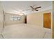 Spacious living room featuring carpet floors, neutral color paint, ceiling fans, and natural light from a large window at 154 Pecan Dr, Ocala, FL 34472