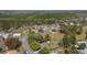 Overhead shot of a residential neighborhood with mature trees, diverse housing, and winding streets at 154 Pecan Dr, Ocala, FL 34472