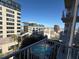 The balcony overlooks neighborhood, providing great views of nearby buildings and a pool at 155 S Court Ave # 1506, Orlando, FL 32801