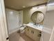 Bright bathroom with a tub, tiled floors, and vanity with a round mirror at 155 S Court Ave # 1506, Orlando, FL 32801