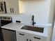 Close-up of modern kitchen featuring stainless steel sink and countertop at 155 S Court Ave # 1506, Orlando, FL 32801