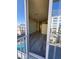 Well-lit living room with modern flooring and balcony access, overlooking the pool at 155 S Court Ave # 1506, Orlando, FL 32801