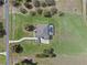 Bird's eye view of a large property, showcasing a home with a pool and extensive landscaping in a serene, natural setting at 15523 Trotting Horse Ln, Tavares, FL 32778