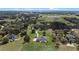 Serene home features large, grassy lawn with mature trees, in-ground pool, and acreage at 15523 Trotting Horse Ln, Tavares, FL 32778