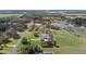 Large, green lawn surrounds this serene property, featuring an in-ground pool at 15523 Trotting Horse Ln, Tavares, FL 32778
