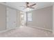 Bedroom with carpet, ceiling fan, and view to an adjacent bathroom at 15523 Trotting Horse Ln, Tavares, FL 32778