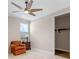 Cozy bedroom with neutral carpet, walk-in closet, and chair beside small side table with lamp at 15523 Trotting Horse Ln, Tavares, FL 32778