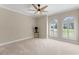 Bright bedroom with neutral carpet, crown molding, and windows dressed with decorative shutters at 15523 Trotting Horse Ln, Tavares, FL 32778