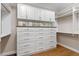 Custom closet featuring built-in shelving, drawers, and cabinetry, perfect for organization and storage at 15523 Trotting Horse Ln, Tavares, FL 32778