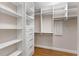 Custom closet featuring built-in shelving, drawers, and cabinetry, perfect for organization and storage at 15523 Trotting Horse Ln, Tavares, FL 32778