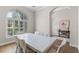 Bright dining room with large windows and a view of the landscaped yard at 15523 Trotting Horse Ln, Tavares, FL 32778