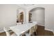 Bright dining room with a view of the archways and hardwood floors at 15523 Trotting Horse Ln, Tavares, FL 32778
