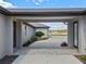 Elegant home's driveway featuring a beautiful brick paver accent leading to a spacious concrete parking area and lush landscaping at 15523 Trotting Horse Ln, Tavares, FL 32778