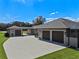 A sprawling home with a long driveway and three car garage at 15523 Trotting Horse Ln, Tavares, FL 32778