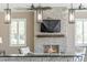 Bar area with stone fireplace, mounted TV, recessed lighting, and white plantation shutters at 15523 Trotting Horse Ln, Tavares, FL 32778
