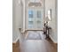 Inviting foyer with hardwood floors, a decorative rug, and stylish console table with decorative lamp at 15523 Trotting Horse Ln, Tavares, FL 32778
