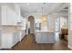 Spacious kitchen showcases white cabinets, stainless steel appliances, and a large center island with pendant lights at 15523 Trotting Horse Ln, Tavares, FL 32778