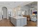 Bright kitchen boasts a large island, stainless steel appliances, pendant lights, and hardwood flooring at 15523 Trotting Horse Ln, Tavares, FL 32778