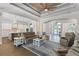 Open concept living room with hardwood floors, ceiling fan, and view of the kitchen at 15523 Trotting Horse Ln, Tavares, FL 32778