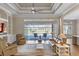 Spacious living room with ceiling fan, hardwood floors, and sliding glass doors to outdoor pool at 15523 Trotting Horse Ln, Tavares, FL 32778