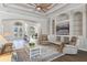 Spacious living room with hardwood floors, ceiling fan, and entertainment center at 15523 Trotting Horse Ln, Tavares, FL 32778