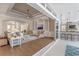 Open-concept living room and bar with hardwood floors, recessed lighting, sliding glass doors, and custom millwork at 15523 Trotting Horse Ln, Tavares, FL 32778