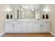 Bright, spacious main bathroom featuring a double vanity with white cabinets and marble countertops at 15523 Trotting Horse Ln, Tavares, FL 32778